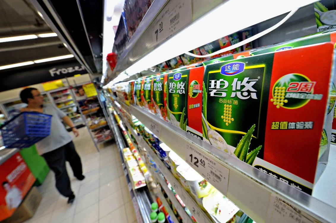 A man shops in a supermarket where Danone yogurts are displayed in Shanghai. (AFP)