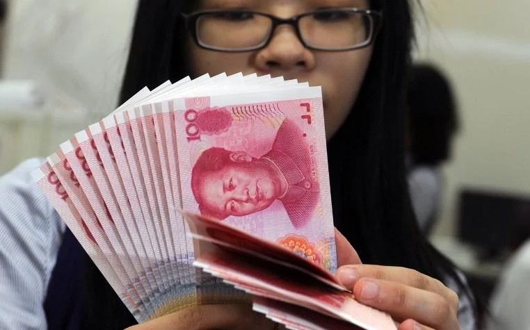 China could bolster confidence in the yuan by engaging in more market-friendly reforms. (AFP)