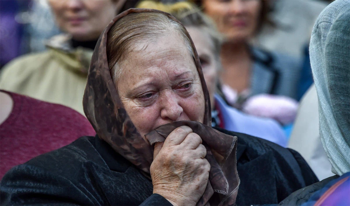 A woman cries during a church service for the victims of the college attack in Kerch, Crimea, on Oct. 18, 2018. (AFP)