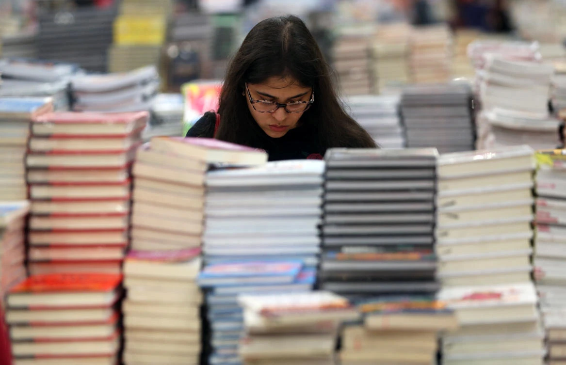 A visitor reads a book at the Big Bad Wolf Book Sale, which calls itself the world's biggest, hosted for the first time by Dubai, UAE October 17, 2018. Picture taken October 17, 2018. (Reuters)