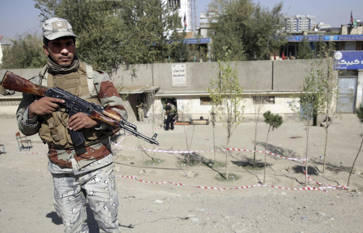 A policeman stands guard after a bomb explosion near a polling station in Kabul, Afghanistan, Saturday, Oct. 20, 2018. (AP/Massoud Hossaini)