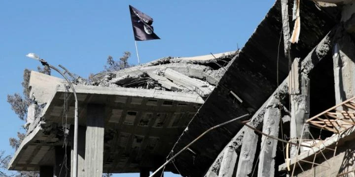 A Daesh flag is pictured above a destroyed house near the Clock Square in Raqqa, Syria, Oct. 18, 2017. (Reuters)