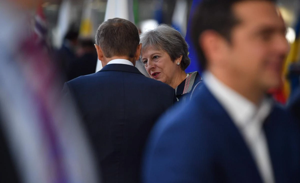 Britain’s Prime Minister Theresa May, center, speaks with European Council President Donald Tusk during a summit at the European Council in Brussels on Friday, October 19. (AFP)