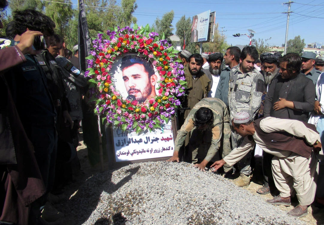 People attend a burial ceremony of General Abdul Razeq, the Kandahar police commander, who was killed in an attack, in Kandahar province, Afghanistan October 19, 2018. (Reuters)