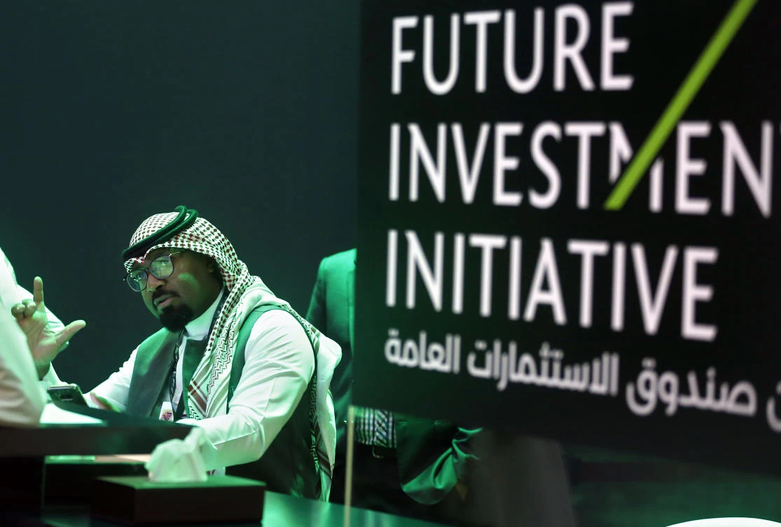 A Saudi employee prints badges of participants of the Future Investment Initiative conference, which kicks off Tuesday, in Riyadh, Saudi Arabia, Monday, Oct. 22, 2018. (AP)