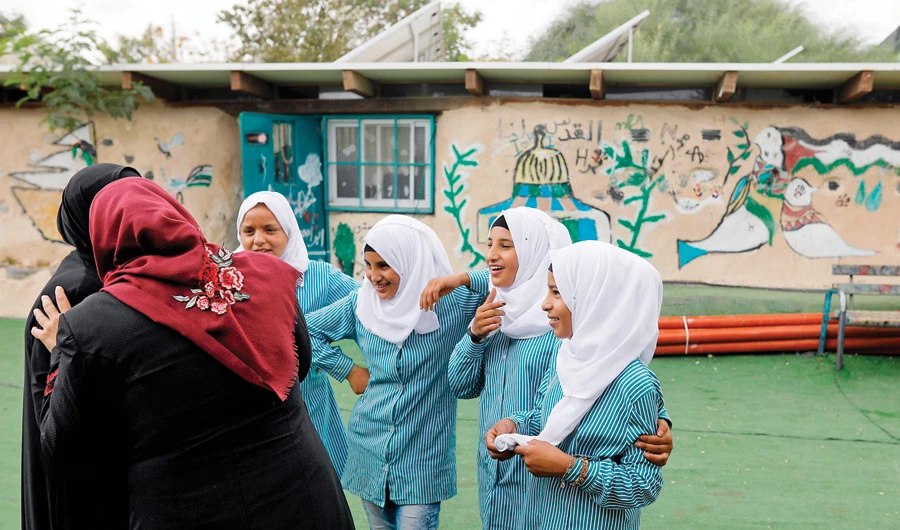 Girls play in their school yard in the Palestinian village of Khan Al-Ahmar, east of Jerusalem. Israel has frozen plans to demolish the village that has drawn the world’s attention. (AFP)