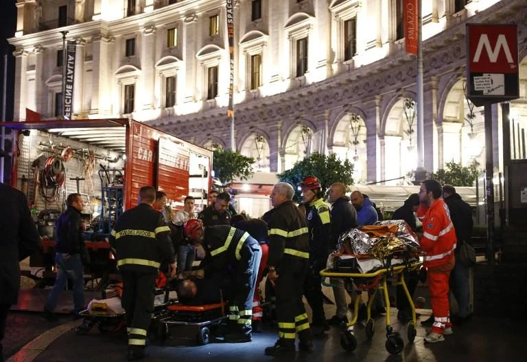 First responders enter the underground access with stretchers to evacuate wounded persons in central Rome on Tuesday, October 23. (AFP)