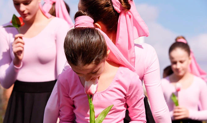 Kosovan girls dressed as ballet dancers hold roses and perform in front of the National Theatre on October 10, 2018 during the International Breast Cancer Awareness Month, to raise awareness on breast cancer and to promote prevention. (AFP)