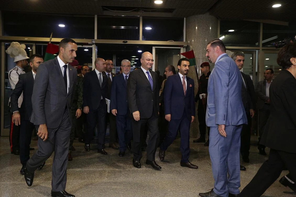 Iraqi President Barham Salih, center, and Parliament Speaker Mohammed Al-Halbousi, center right, arrive to the parliament building, in the heavily guarded Green Zone, in Baghdad, Iraq, Wednesday, Oct. 24, 2018. (AP)