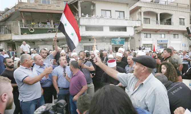 Druze residents in the Golan Heights set ablaze makeshift ballot papers during a recent protest against the elections in the occupied region. (AFP)