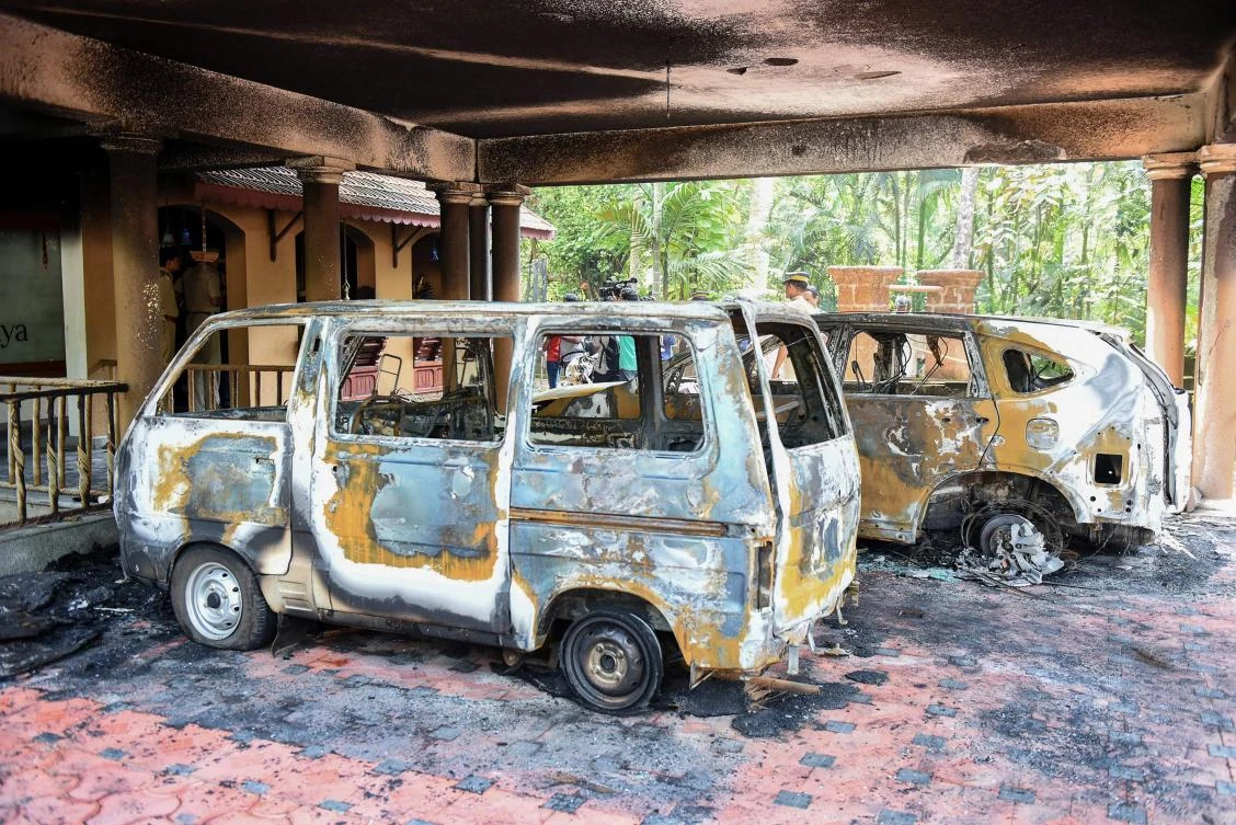 Charred vehicles are pictured at a spiritual retreat after it was set ablaze in Kundamankadavu, as suspected Hindu radicals on attacked a spiritual retreat founded by a preacher who backed letting women enter a renowned Indian temple. (AFP)