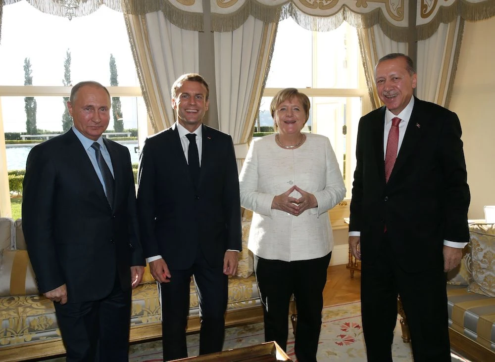 Russian President Vladimir Putin, French President Emmanuel Macron, German Chancellor Angela Merkel and Turkish President Recep Tayyip Erdogan pose during the "Four-way Istanbul summit on Syria", at Vahdettin Mansion in Istanbul, on October 27, 2018. (AFP)