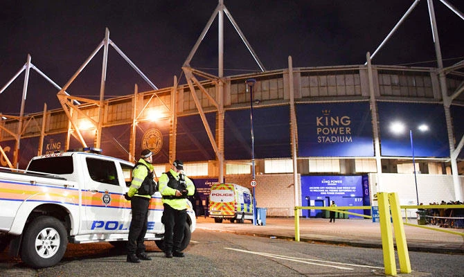 Police officers secure the area outside Leicester City Football Club's King Power Stadium in Leicester, eastern England, on October 27, 2018 after a helicopter crashed in a car park outside the stadium. (AFP)