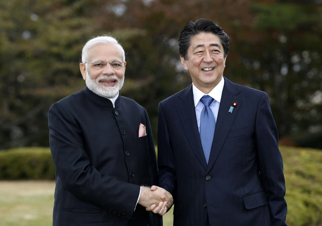 India’s Prime Minister Narendra Modi, left, shakes hands with Japan’s Prime Minister Shinzo Abe in Yamanakako village, Yamanashi prefecture, Sunday, Oct. 28, 2018. (AP/Kyodo News/Suo Takekuma)