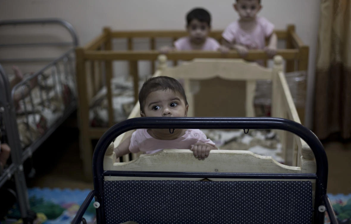 Baby girls stand up in their cribs at Salhiya Orphanage, which now hosts foreign and Iraqi children of Islamic State militants, in Baghdad, Iraq. (File/AP/Maya Alleruzzo)