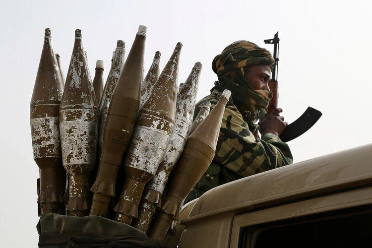 A Chadian soldier rides atop a pickup truck next to a bag of rocket-propelled grenades in Gambaru, Nigeria, February 26, 2015. (Reuters)