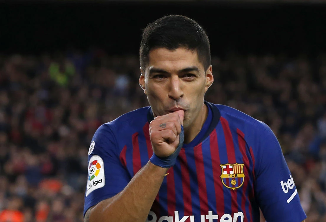 Barcelona forward Luis Suarez celebrates after scoring his side's fourth goal during the Spanish La Liga soccer match between FC Barcelona and Real Madrid at the Camp Nou. (AP) Photo/Joan Monfort)