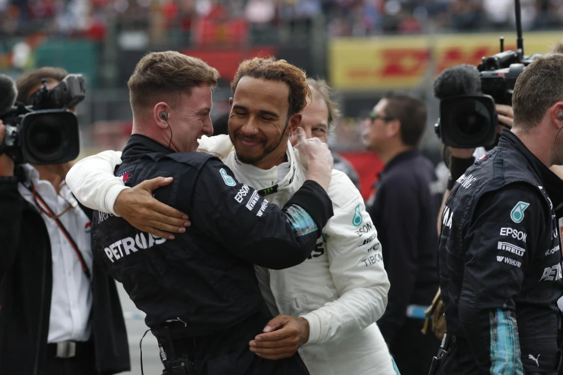 Mercedes driver Lewis Hamilton is congratulated by a member of his crew after becoming the Formula One champion during the Mexico Grand Prix. (AP)