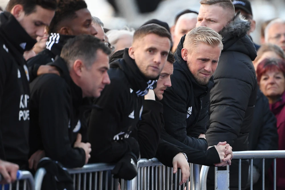 Leicester City’s Danish goalkeeper Kasper Schmeichel, right, stands beside Leicester City’s English striker Jamie Vardy as they look at the floral tributes left to the victims of the helicopter crash outside Leicester City Football Club’s King Power Stadium. (AFP)