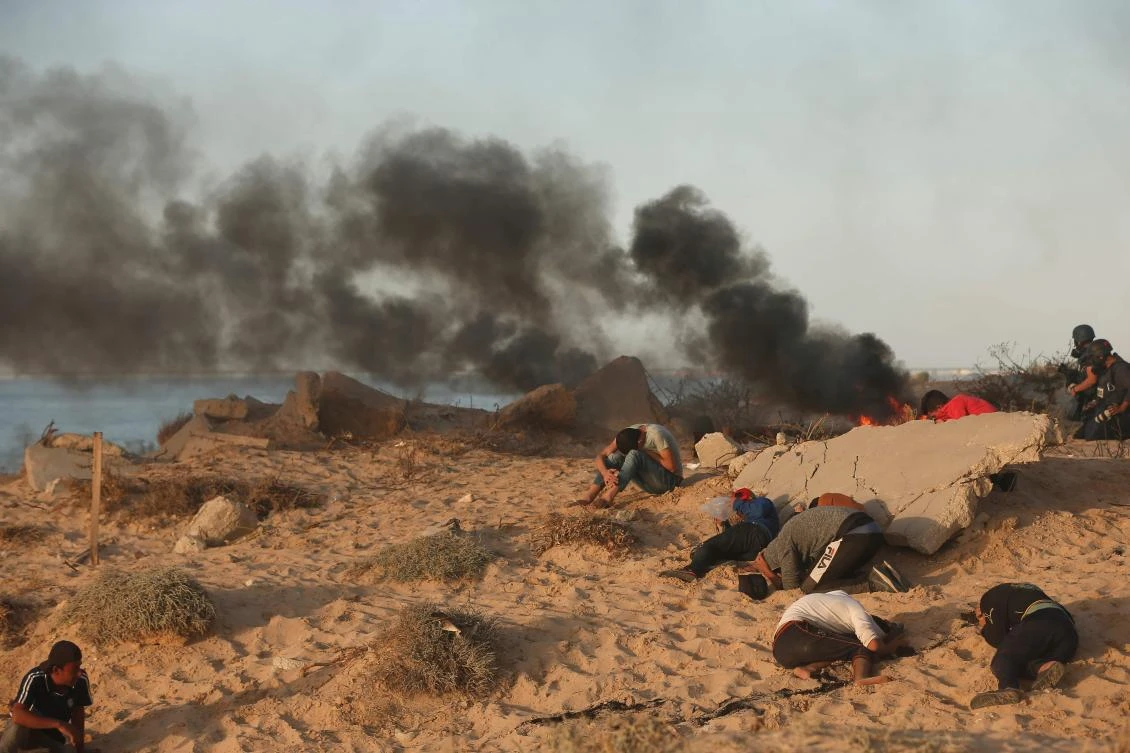 Palestinian protesters burn tires during a demonstration on the beach near the maritime border with Israel, in Beit Lahia in the northern Gaza Strip, on October 29, 2018. (AFP)