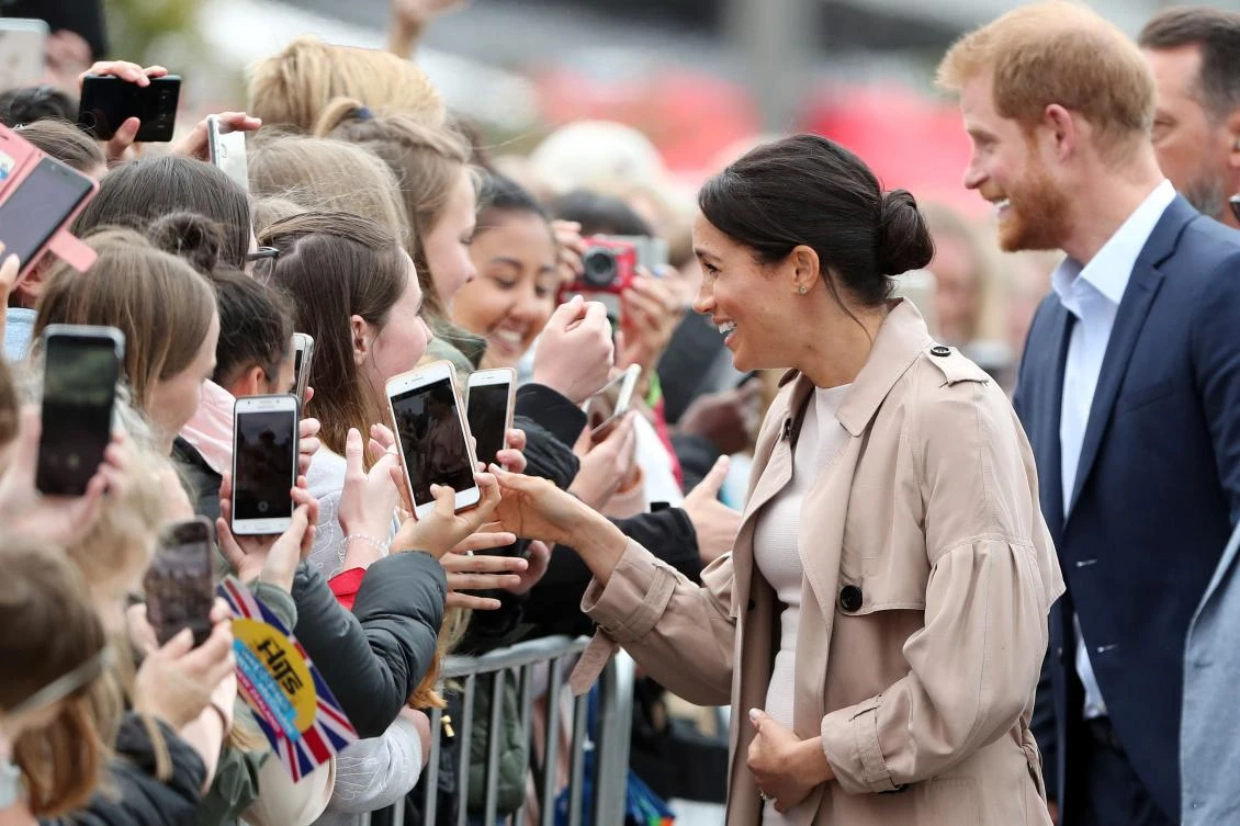 Britain’s Prince Harry and his wife Meghan, Duchess of Sussex greet people during a public walkabout at the Vivaduct Harbor in Auckland on, Tuesday, October 30. (AFP)