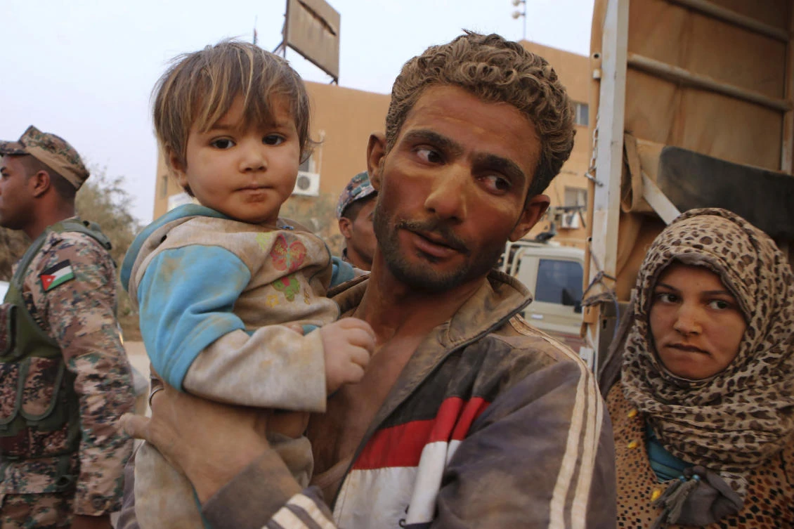 Tens of thousands of Syrians stranded in a desert camp near the Jordanian border are at risk of malnutrition amid dwindling humanitarian supplie. (AP/Raad Adayleh)