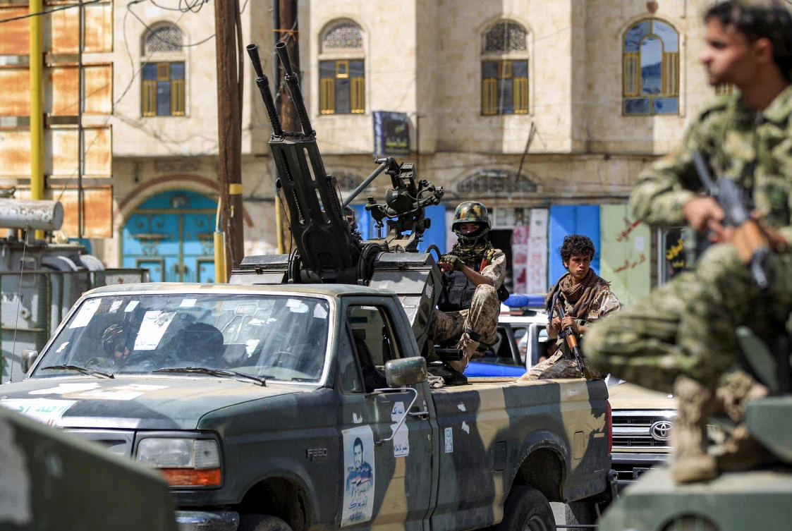 A Yemeni soldier loyal to the Houthis mans a turret in the back of a pickup truck during a military parade in the capital Sanaa. (AFP)