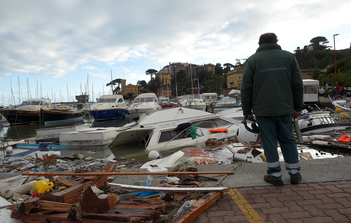 A man looks at destroyed yachts which lie on the shore after windstorm and the strong sea storm in Rapallo. (Reuters)