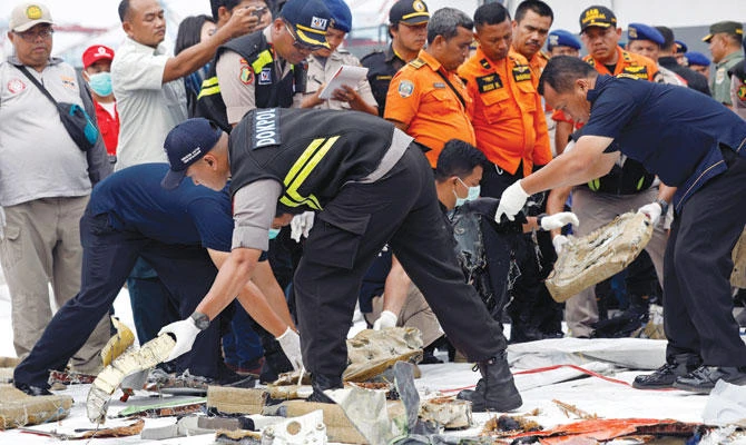 Rescue workers lay out newly recovered debris of Lion Air flight JT610 at Tanjung Priok port in Jakarta Tuesday. (Reuters)