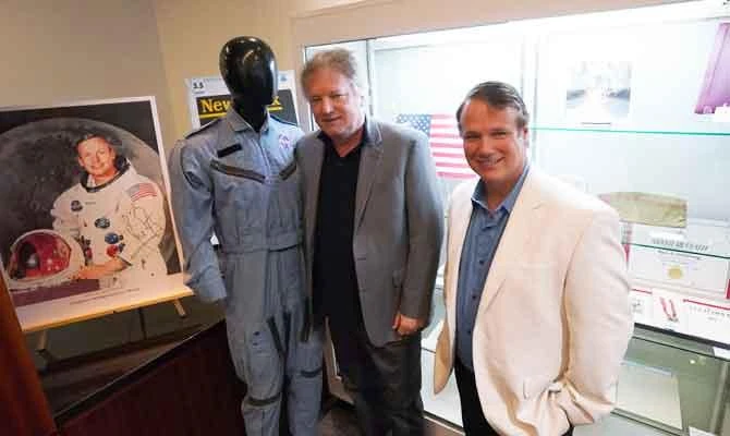 Neil Armstong's sons Rick (L) and Mark pose for a photo with items that belonged to their father at Heritage Auctions October 2, 2018 in New York. (AFP)