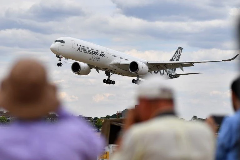 Visitors watch as an Airbus A330-900 Neo lands during the Farnborough Airshow, south west of London, on July 16. (AFP)