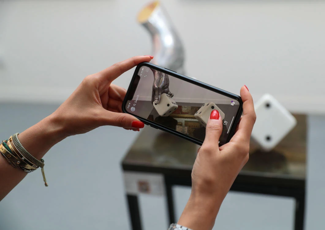 A young woman captures a photograph at The Saudi Gallery. (Basheer Saleh/AN)