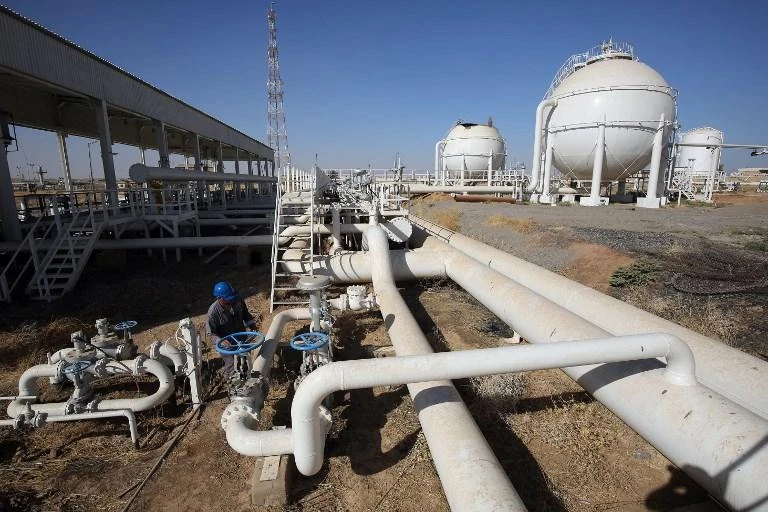 An employee checks pipelines at the Bai Hassan oil field west of Kirkuk in Iraq, on October 19, 2017. (AFP)