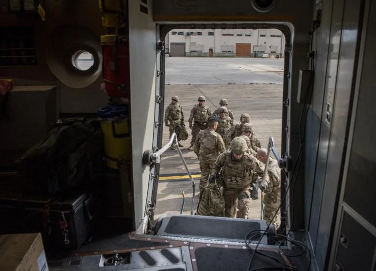 Soldiers from Headquarters Company, 89th Military Police Brigade, Task Force Griffin board a C-17 Globemaster III to support Operation Faithful Patriot. (Northcom Public Affairs/AFP)