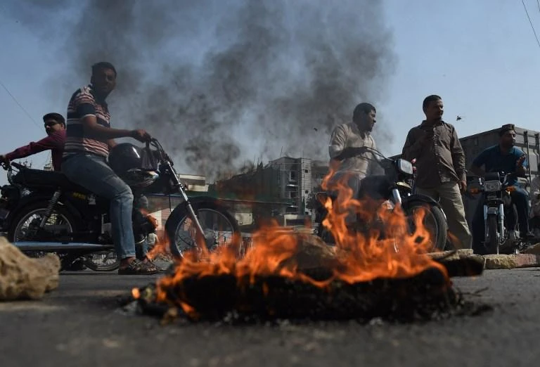 Protesters block a road during a demonstration in Karachi on Wednesday, October 31, against a court decision to overturn the conviction of a Christian woman for blasphemy. (AFP)