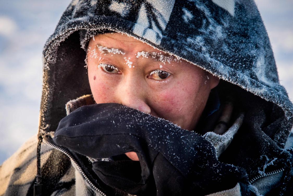 Villagers harvest ice from a local lake near the settlement of Oy, some 70 km south of Yakutsk, with the air temperature at about minus 41 degrees Celsius, on November 27, 2018. Many people in the Sakha (Yakutia) Republic depend on melted water as there is no other way to supply water due to extremely cold winter temperatures in the permafrost-covered region. / AFP / Mladen ANTONOV