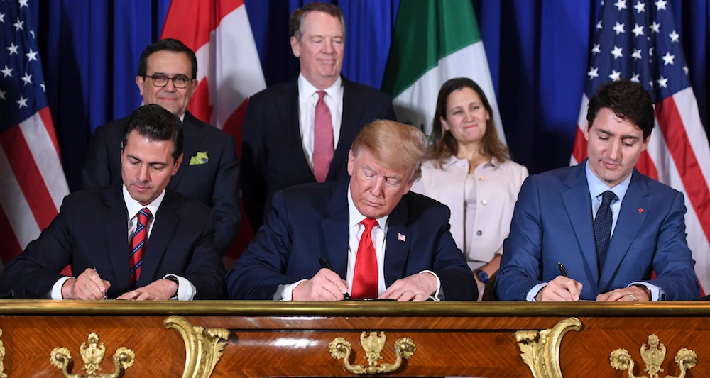 Mexico's President Enrique Pena Nieto (L) US President Donald Trump (C) and Canadian Prime Minister Justin Trudeau, sign a new free trade agreement in Buenos Aires, on November 30, 2018, on the sidelines of the G20 Leaders' Summit. (AFP)