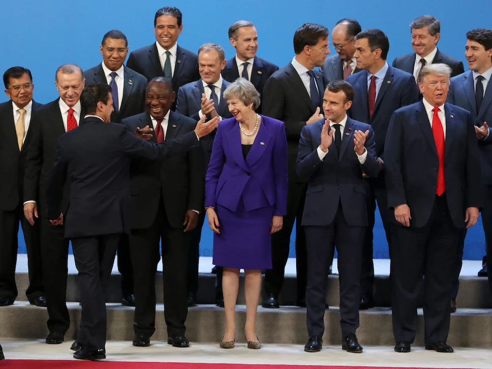 Mexico's President Enrique Pena Nieto waves as he arrives last to the family photo of the G20 Leader's Summit at the Costa Salguero Center in Buenos Aires, Argentina, Friday, Nov. 30, 2018. (AP)