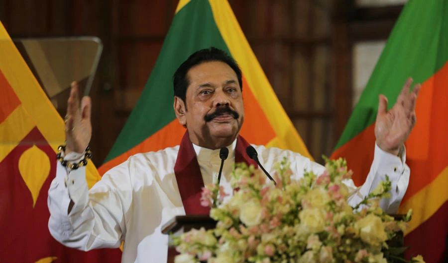 Sri Lankan prime minister Mahinda Rajapaksa gestures as he addresses the staff after assuming duties as finance minister in Colombo, Sri Lanka, on Oct. 31, 2018. (AP Photo/Eranga Jayawardena)
