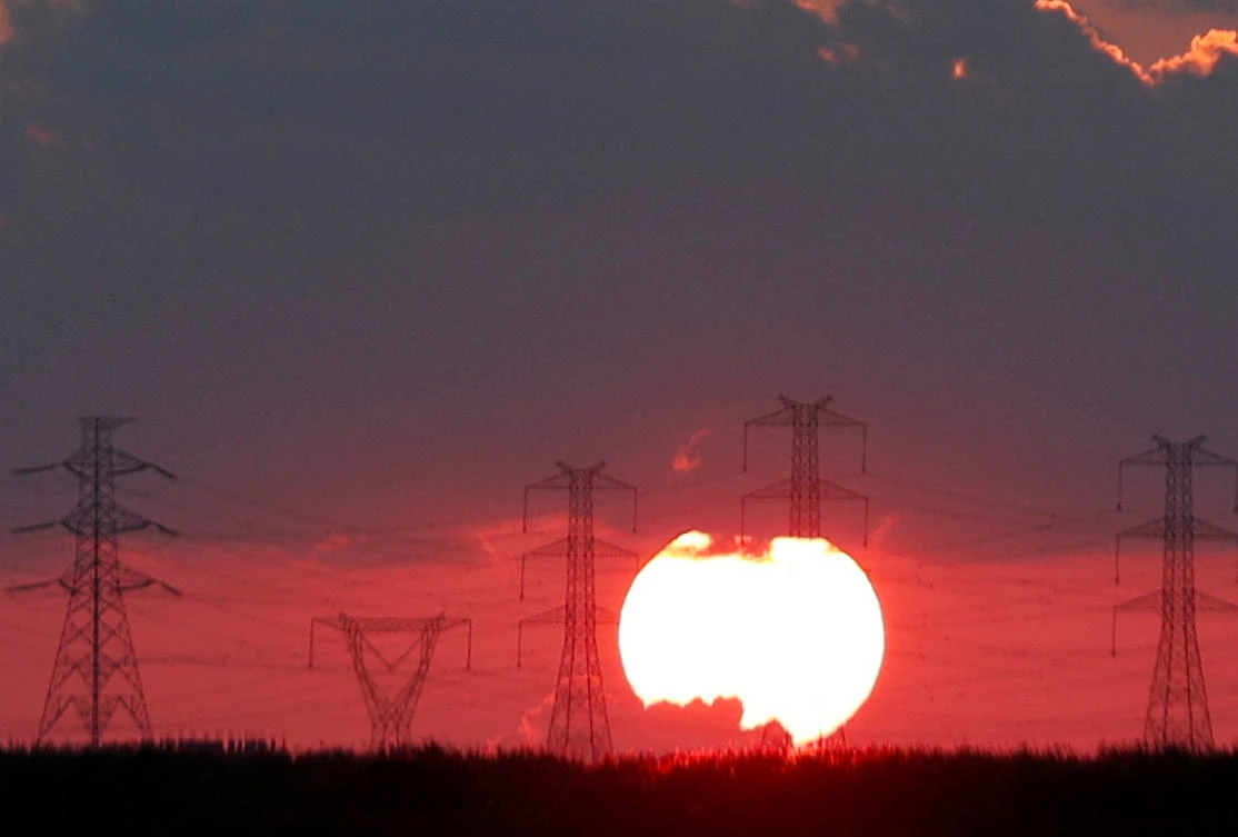 The Sun sets behind high-voltage power lines and electricity pylons at a highway northeast of Cairo, Egypt, September 15, 2018. (Reuters)