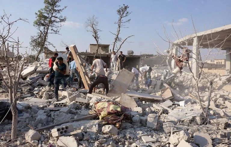 The deaths occurred in the town of Jarjanaz, which lies on the inner edge of the 15-20km demilitarization zone, has been a target of Syrian government attacks such as this one on September 20 last year. (AFP)