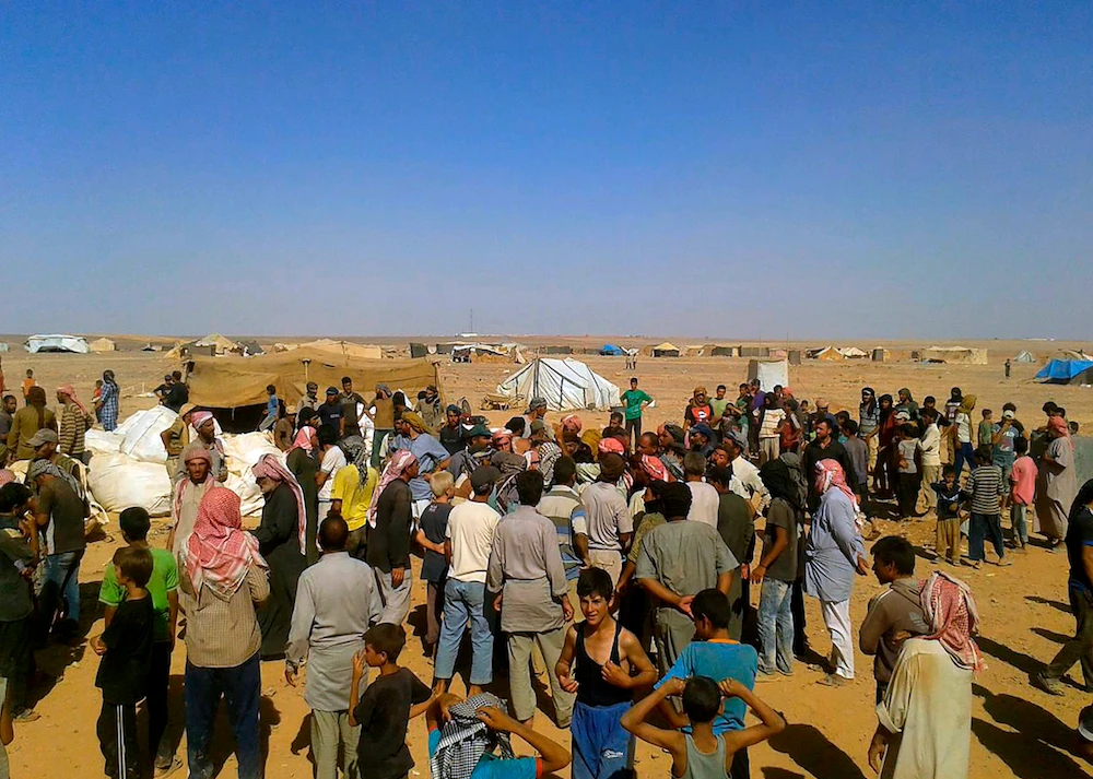 Statements issued by the United Nations and the Syrian Arab Red Crescent said their joint convoy reached Rukban camp and would deliver assistance to 50,000 people. (AP Photo)