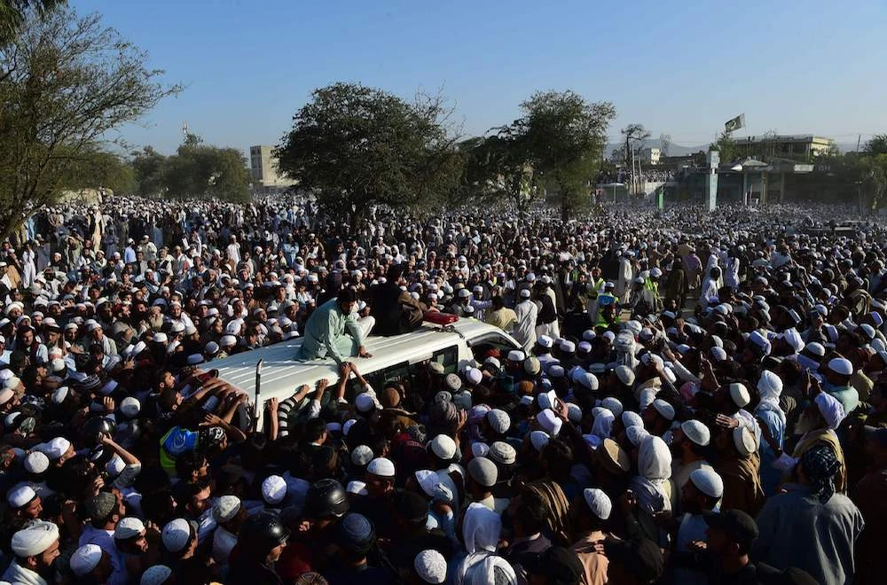 Pakistani supporters gather around an ambulance carrying the body of key cleric Maulana Sami Ul-Haq during his funeral ceremony in his hometown of Akora Khattak. (AFP)
