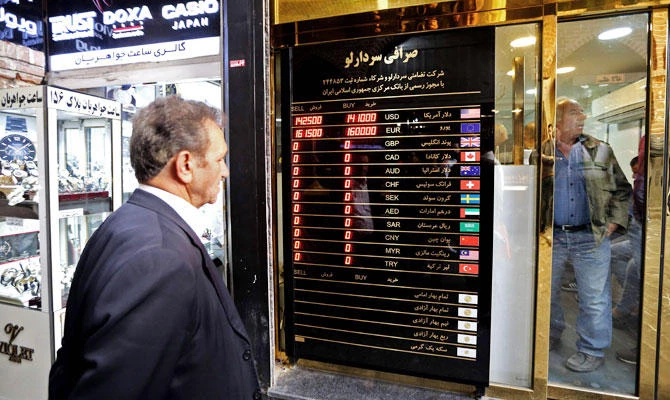 A man checks rates in front of a currency exchange shop in the Iranian capital Tehran's grand bazar on November 3, 2018. (AFP)