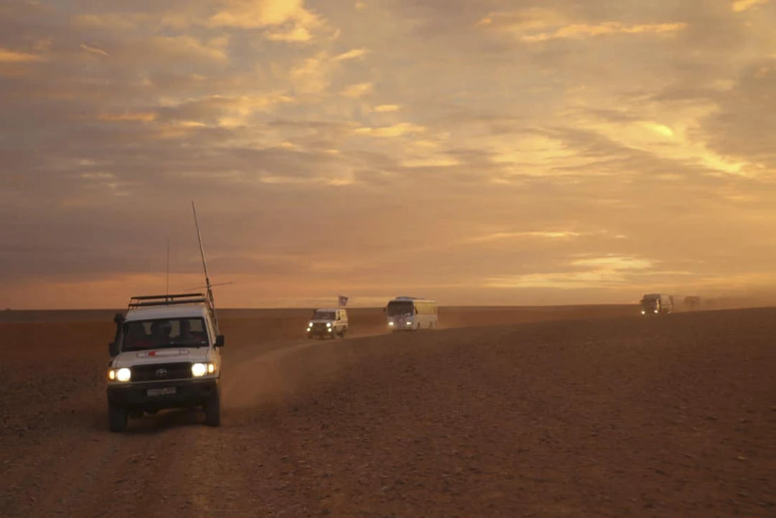A convoy of vehicles of the Syrian Arab Red Crescent driving in the Syrian desert heading to Rukban camp between the Jordan and Syria borders, Sunday, Nov. 4, 2018. (Syrian Arab Red Crescent via AP)
