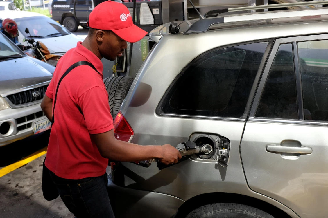 A gas station worker pumps fuel into a car at a gas station of the Venezuelan state-owned oil company PDVSA in Caracas. (Reuters)