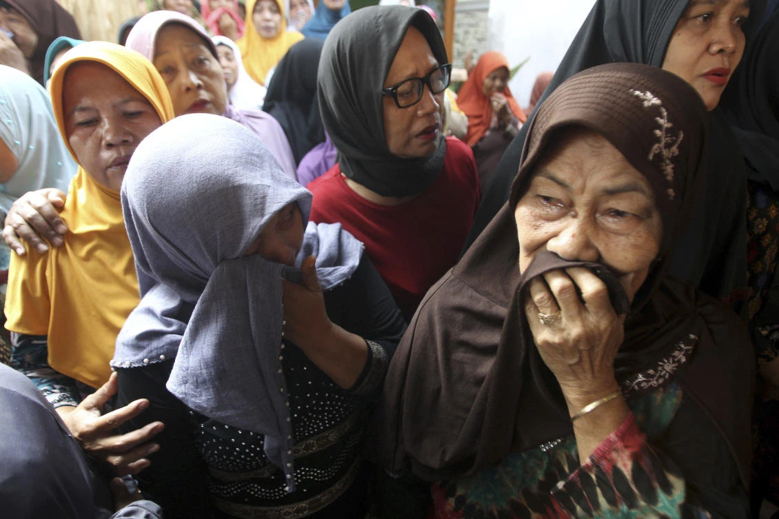 Relatives weep during the funeral of a victim of a Lion Air plane crash, in Sidoarjo, East Java, Indonesia. (AP)