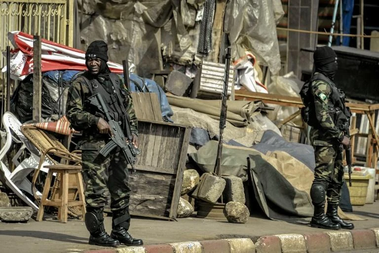 Above, soldiers patrol a street in Bamenda where separatists are fighting to form a breakaway state. (AFP)