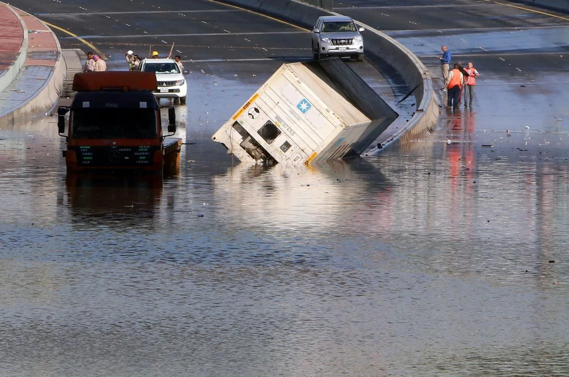 Municipality workers try to drain a flooded underpass in Kuwait City on November 6, 2018, as a result of the accumulation of rainwater. (AFP)