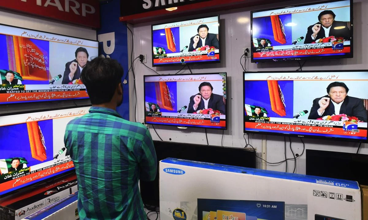 “Begging” ran on screens for 20-25 seconds on Monday while Khan was making a speech in China. (AFP)